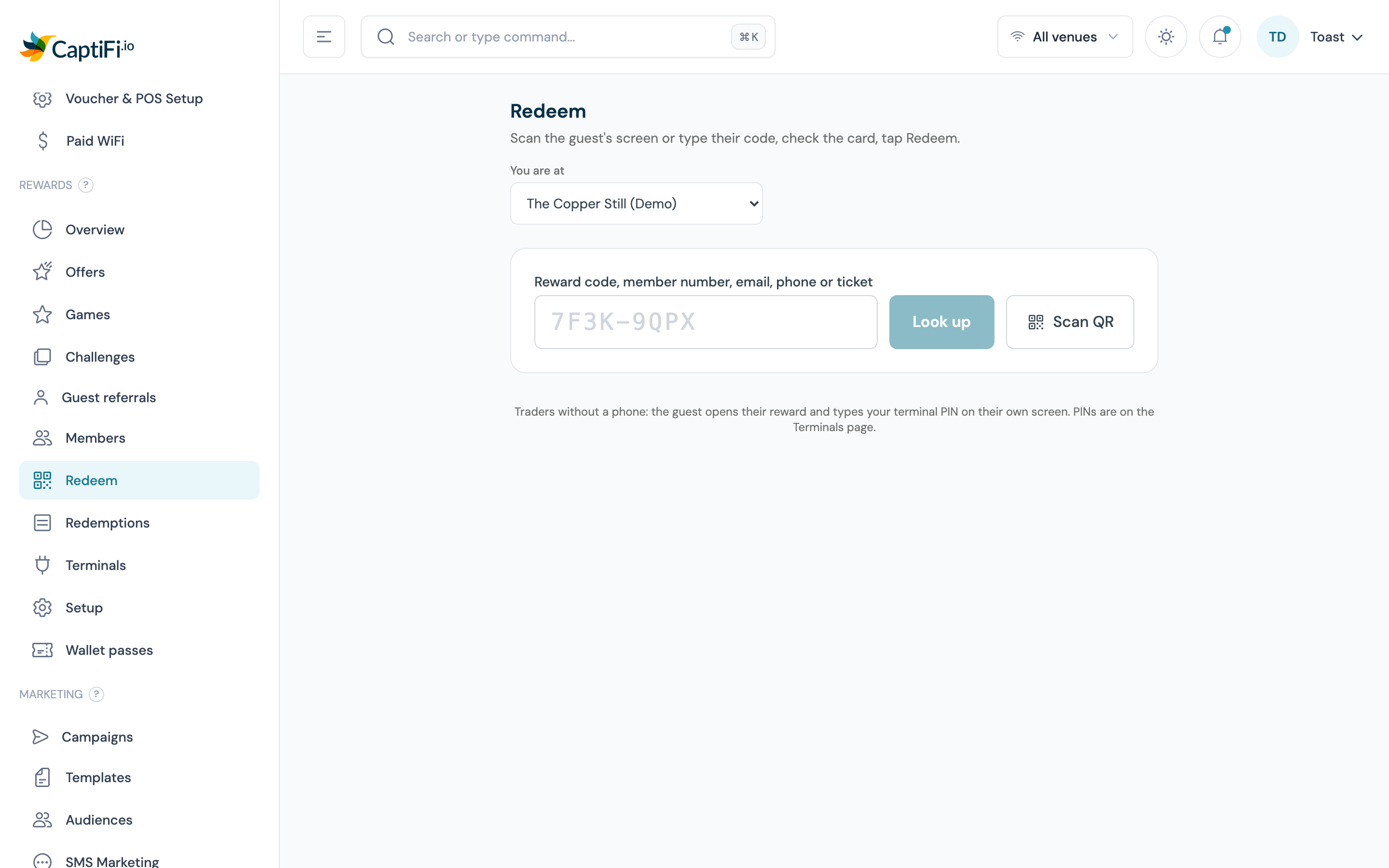 Redeem screen with the You are at venue picker, the typed code box, Look up and Scan QR buttons