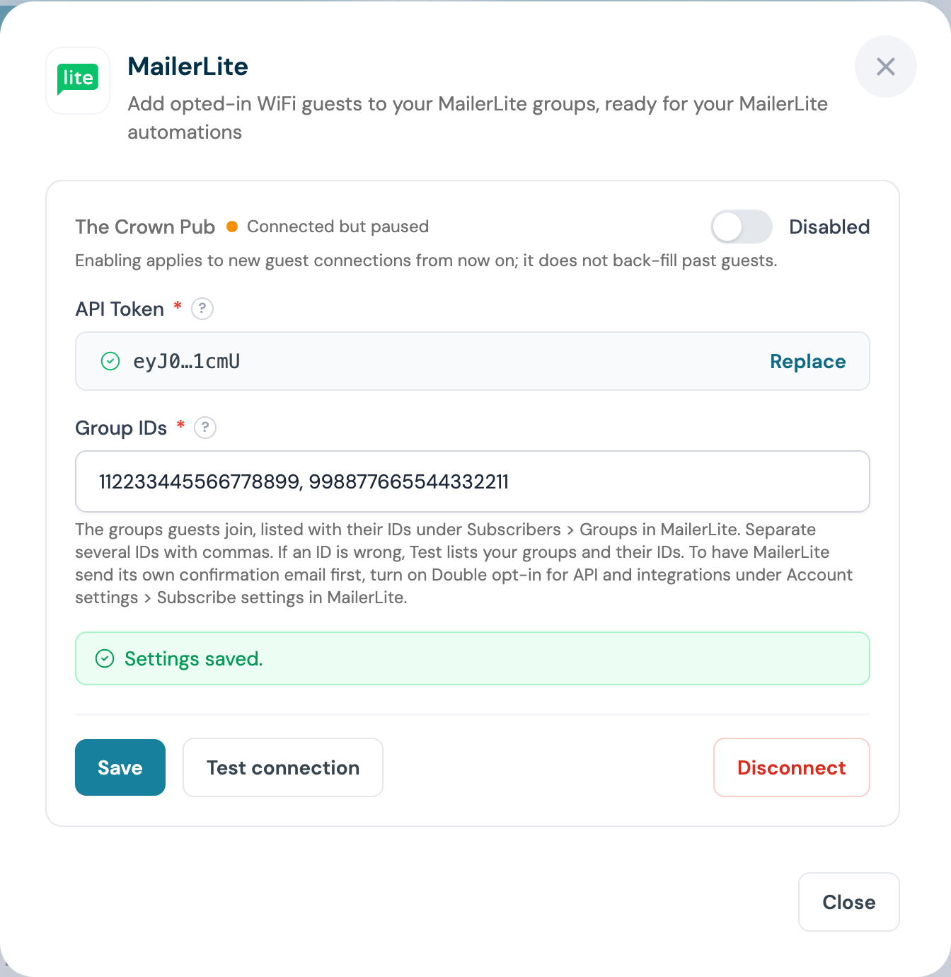 CaptiFi MailerLite panel after saving, showing the masked token, the Replace button and Settings saved